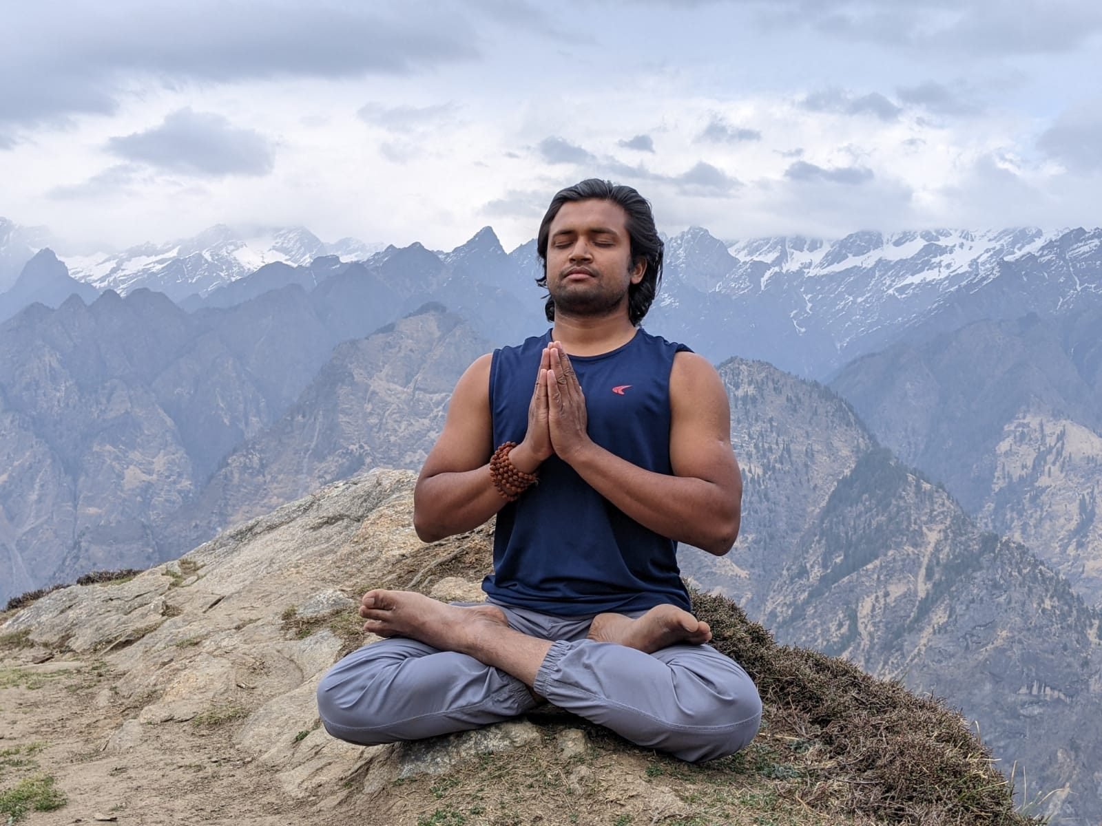 Yogi Gajendra in meditation, hands folded in namaste, during outdoor practice